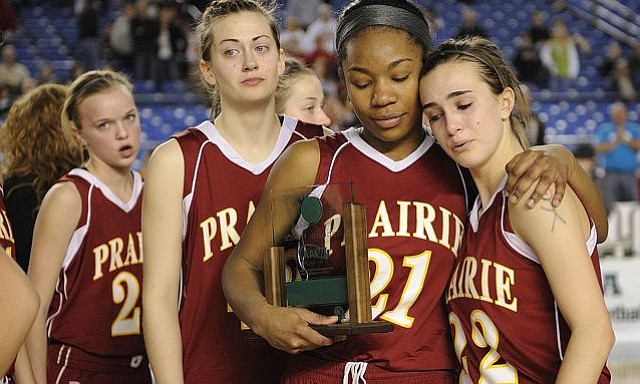 Lanae Adams, 21, of Prairie High School consoles Lauren Goecke, 22, right, after receiving the second place trophy after losing to Holy Names High School at the 2011 Hardwood Classic 3A girls State Basketball Championships at the Tacoma Dome in Tacoma, Washington. Holy Names beat Prairie 57-48. Andrea Smith, 42, and Nicole Goecke, 23, are at left.