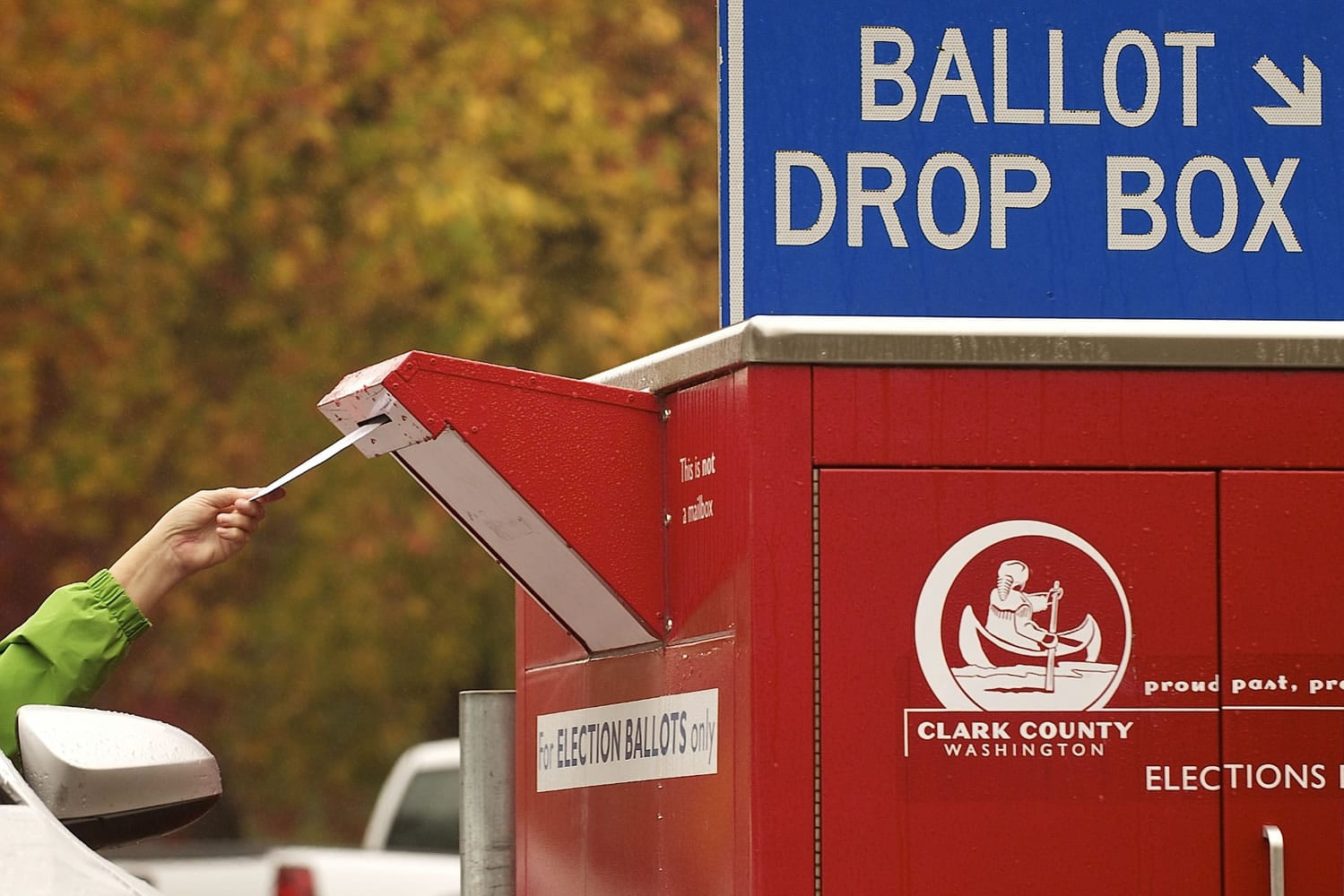 A voter uses a drive-up collection box to cast a ballot on Nov.