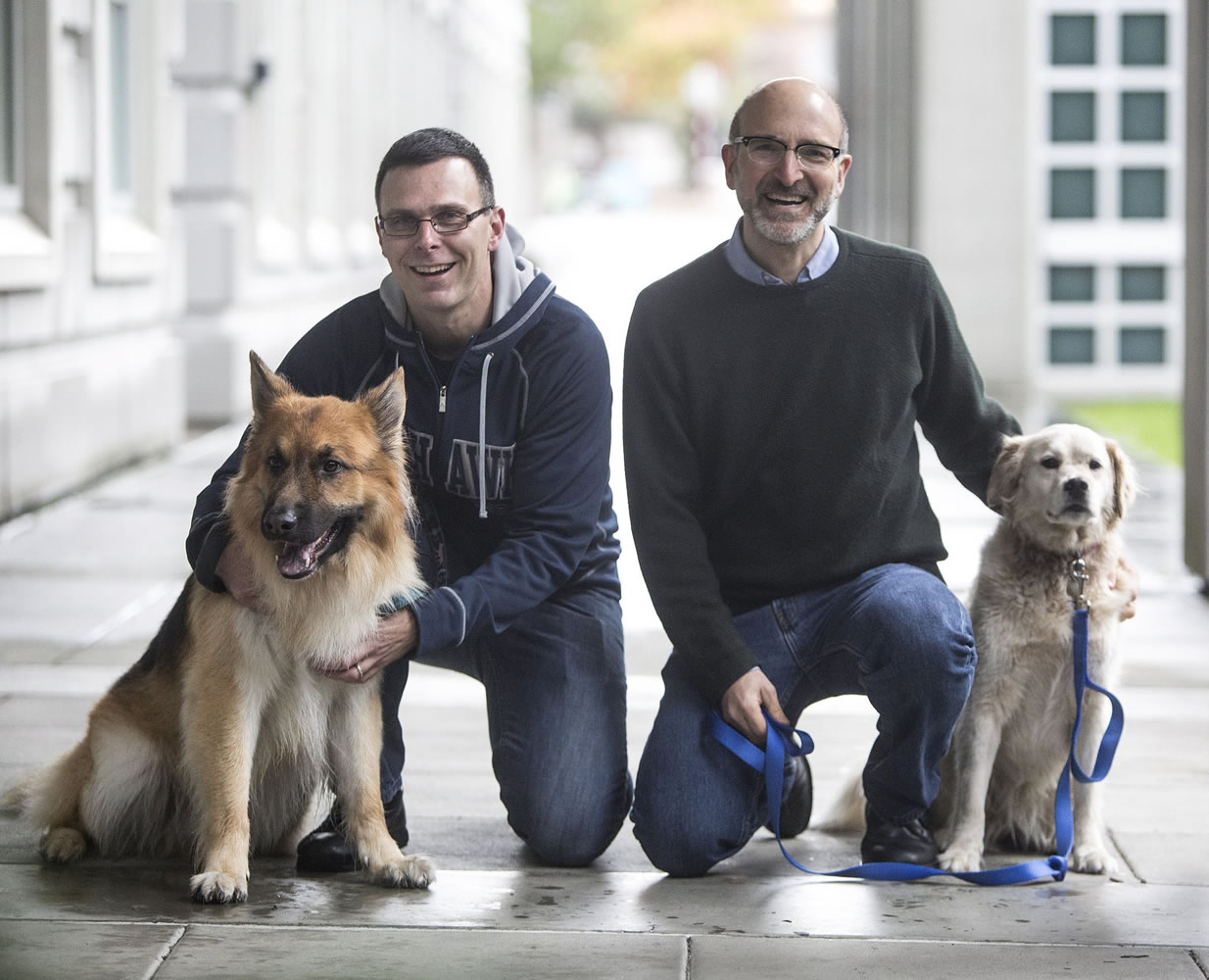 University of Washington scientists Matt Kaeberlein, with his dog Dobby, left, and Dan Promislow, with his dog Frisbee, hope to launch a study of the anti-aging drug rapamycin in pet dogs.