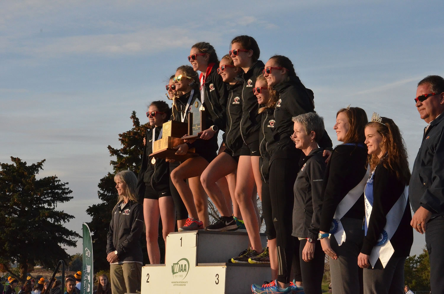 The Camas girls cross country team atop the podium after winning the Class 4A state championship Saturday.