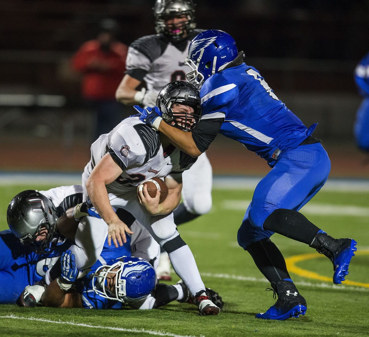 Union's Alex Berfanger earns a hard-fought two yards before being brought down by Federal Way's Andrzej Hughes-Murray