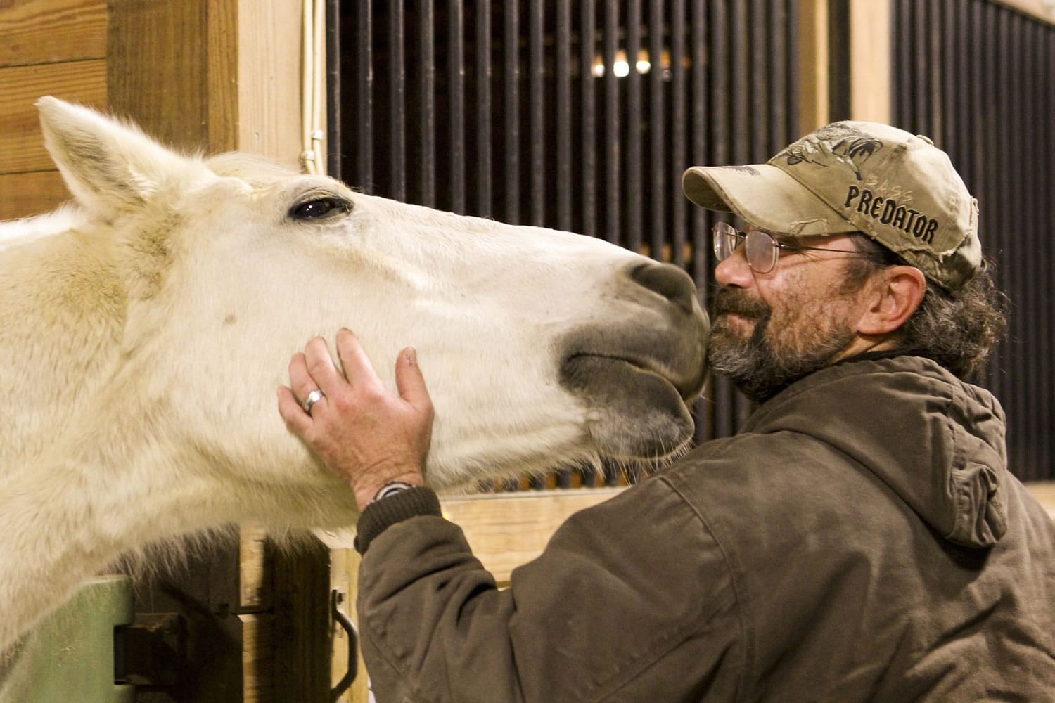 Veteran Jeff Murray pets Smokey Nov. 9 at Pegasus Farm in Hartville, Ohio.