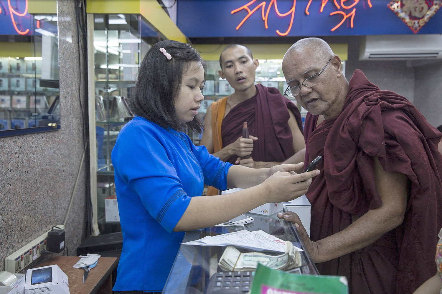 Until recently, few people in once-isolated Myanmar, also known as Burma, had mobile telephones. Here, Buddhist monks receive instruction on new services after buying a phone on Nov.