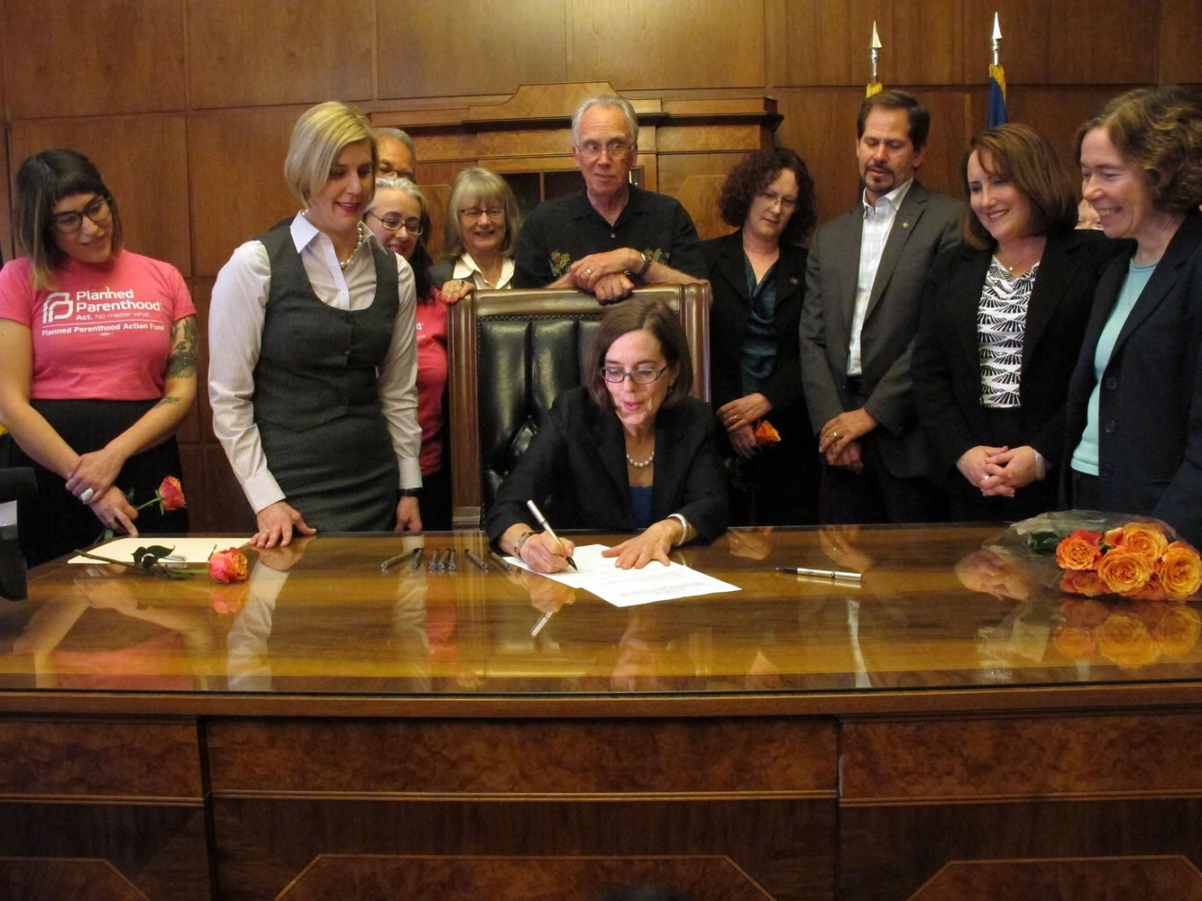 Gov. Kate Brown signs a bill expanding access to contraception during a ceremony Thursday at the state Capitol in Salem, Ore.