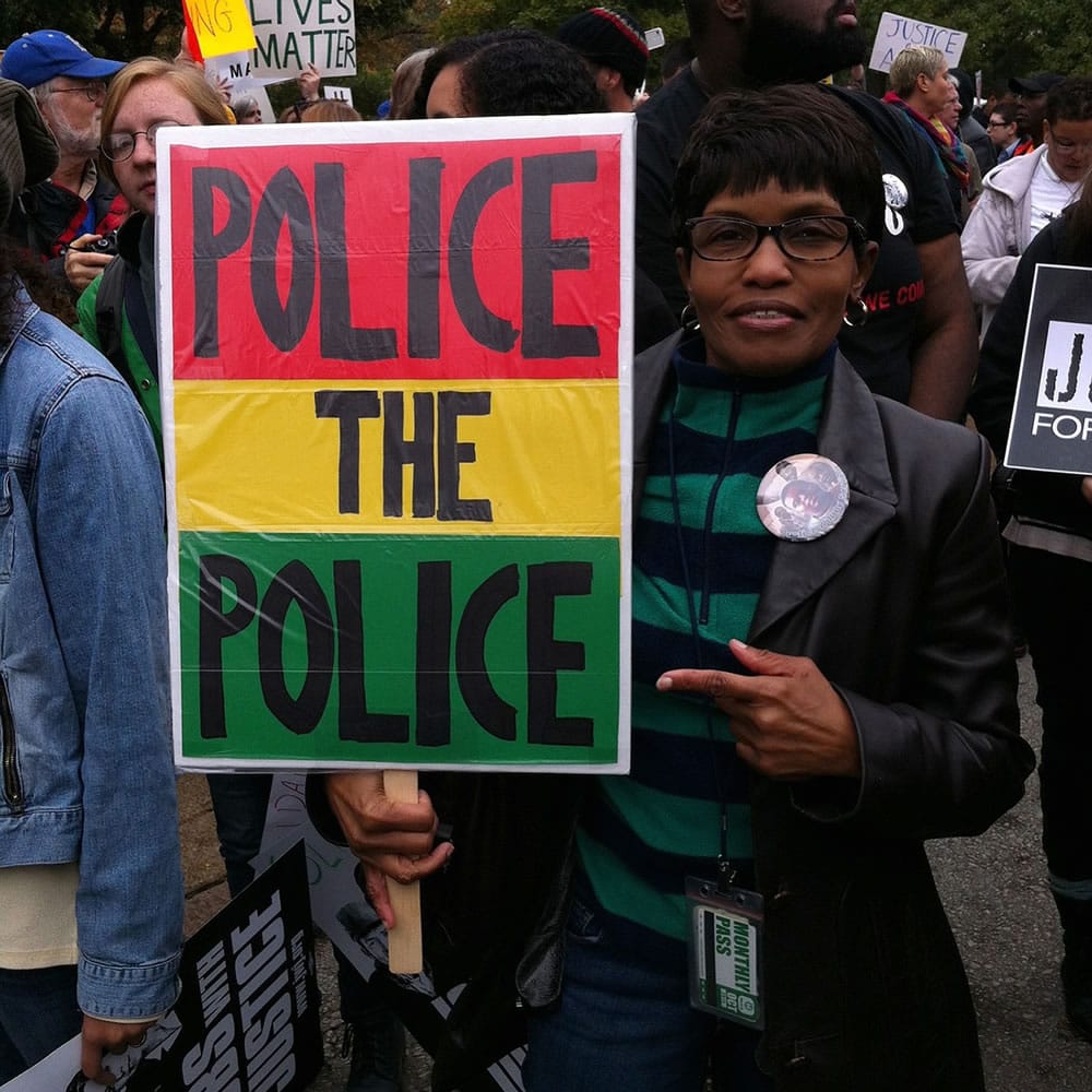 Courtesy of Beverly Adams
Beverly Adams of University City, Mo., shows her sign during the &quot;Ferguson October&quot; protest march. She loaned the sign to the Newseum in Washington, D.C.