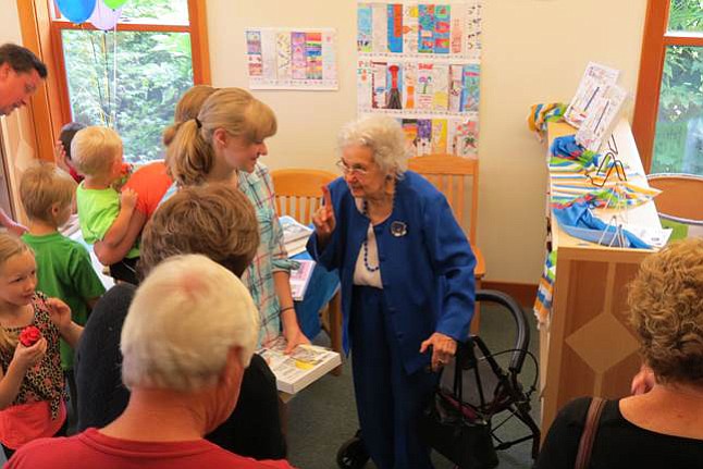 Margaret Colf Hepola, right, chats with Alexa Talvitie-Lynch at the La Center Community Library on June 25 to celebrate the 10th anniversary of the library.