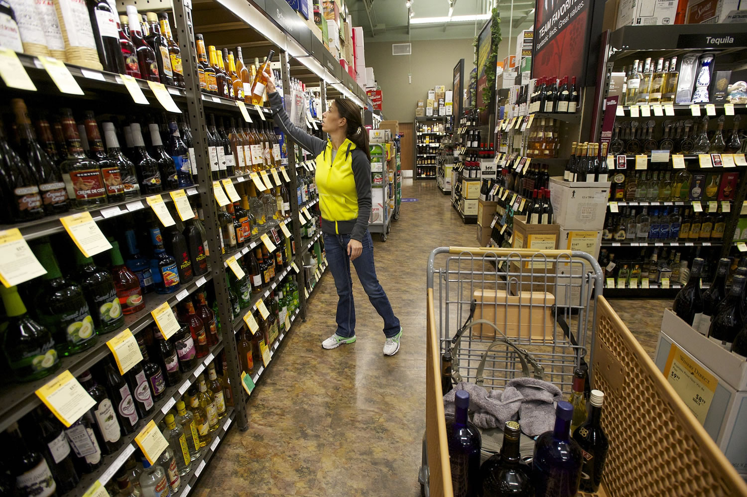 Sally Kasma of Vancouver makes a holiday liquor purchase at Total Wine and More in 2013.