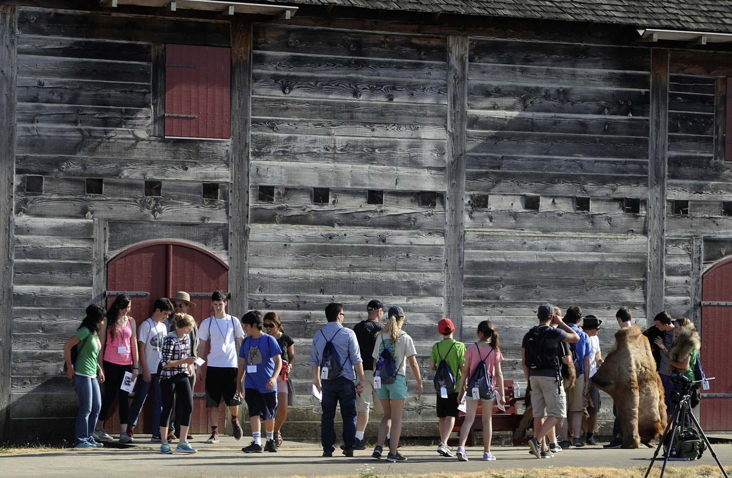 High school students gather at the stockade wall at Fort Vancouver National Historic Site for a selfie scavenger hunt to kick off the Discover Washington: Youth Heritage Project at the fort on Wednesday.
