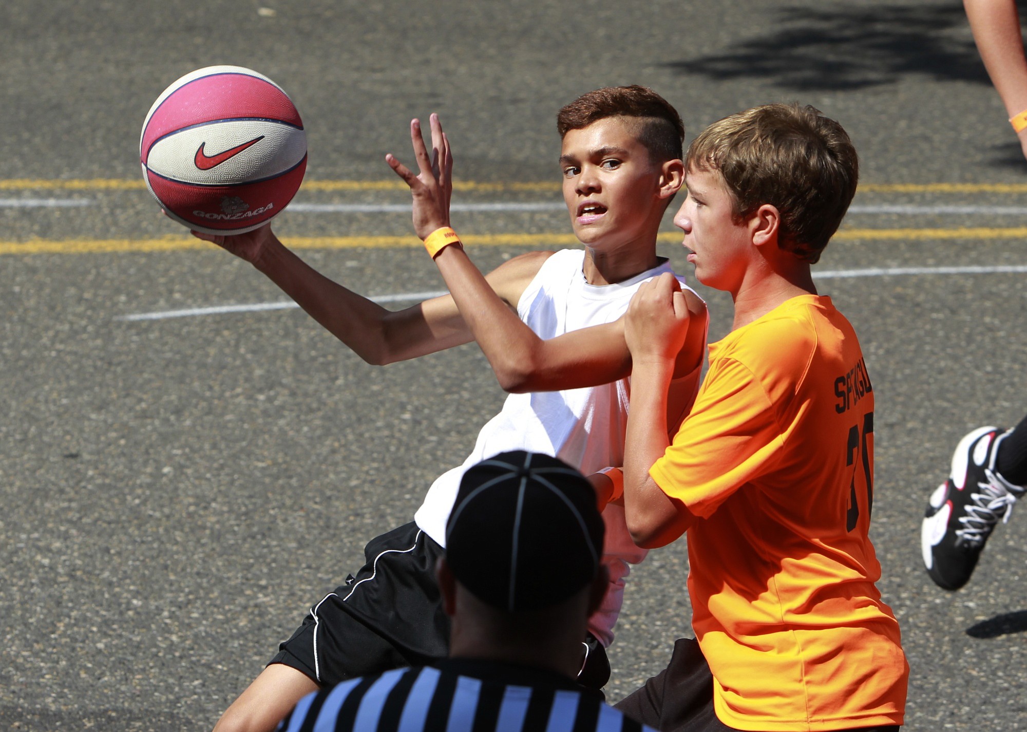 Kyri Greene, left, and Thomas Sprague, right, take part in the Hoops on the River basketball tournament on downtown Vancouver streets Saturday.