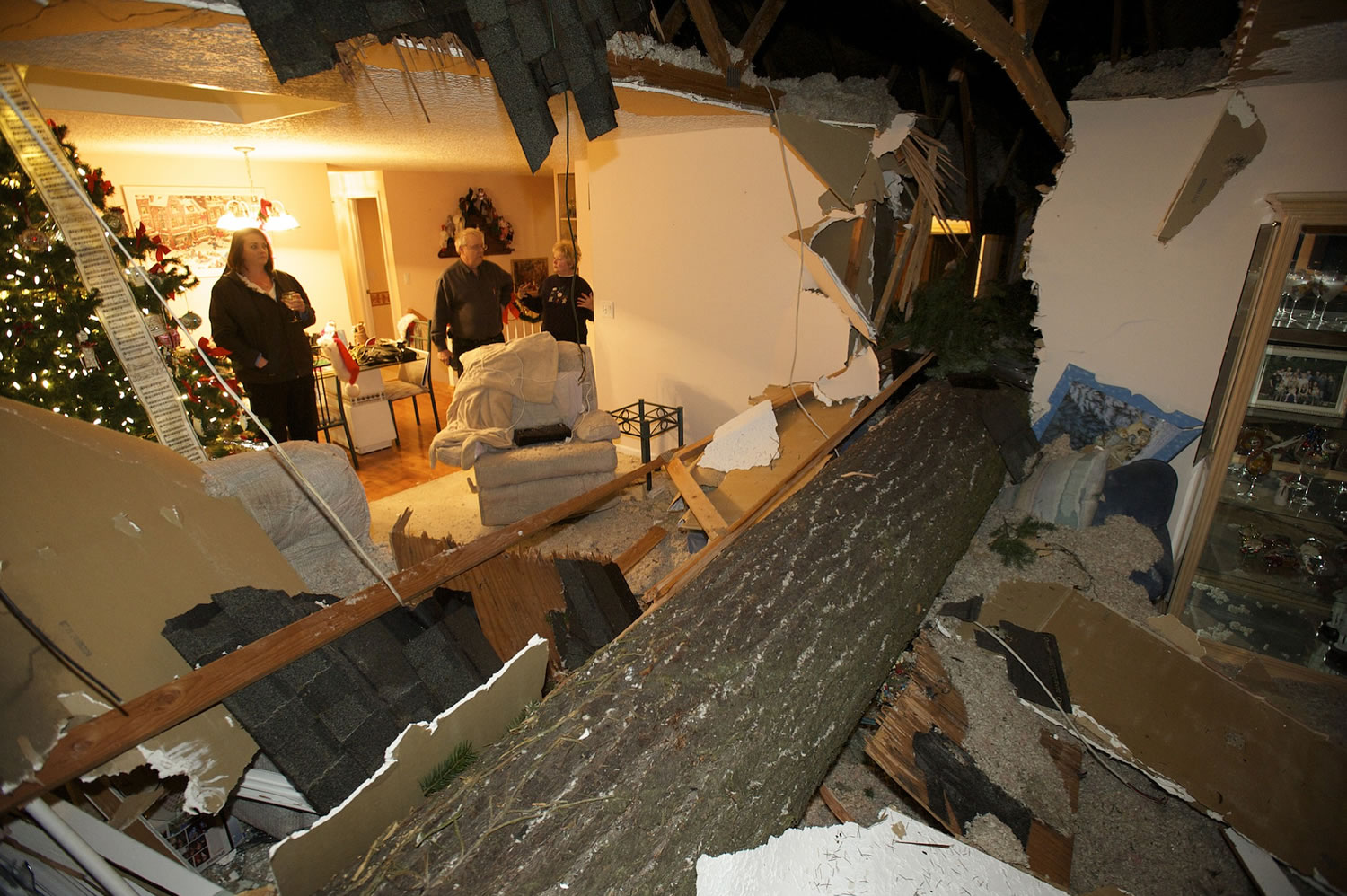 A large fir tree split the home of Ken and Sharon Thiesmeyer as high winds blew through Clark County on Thursday.