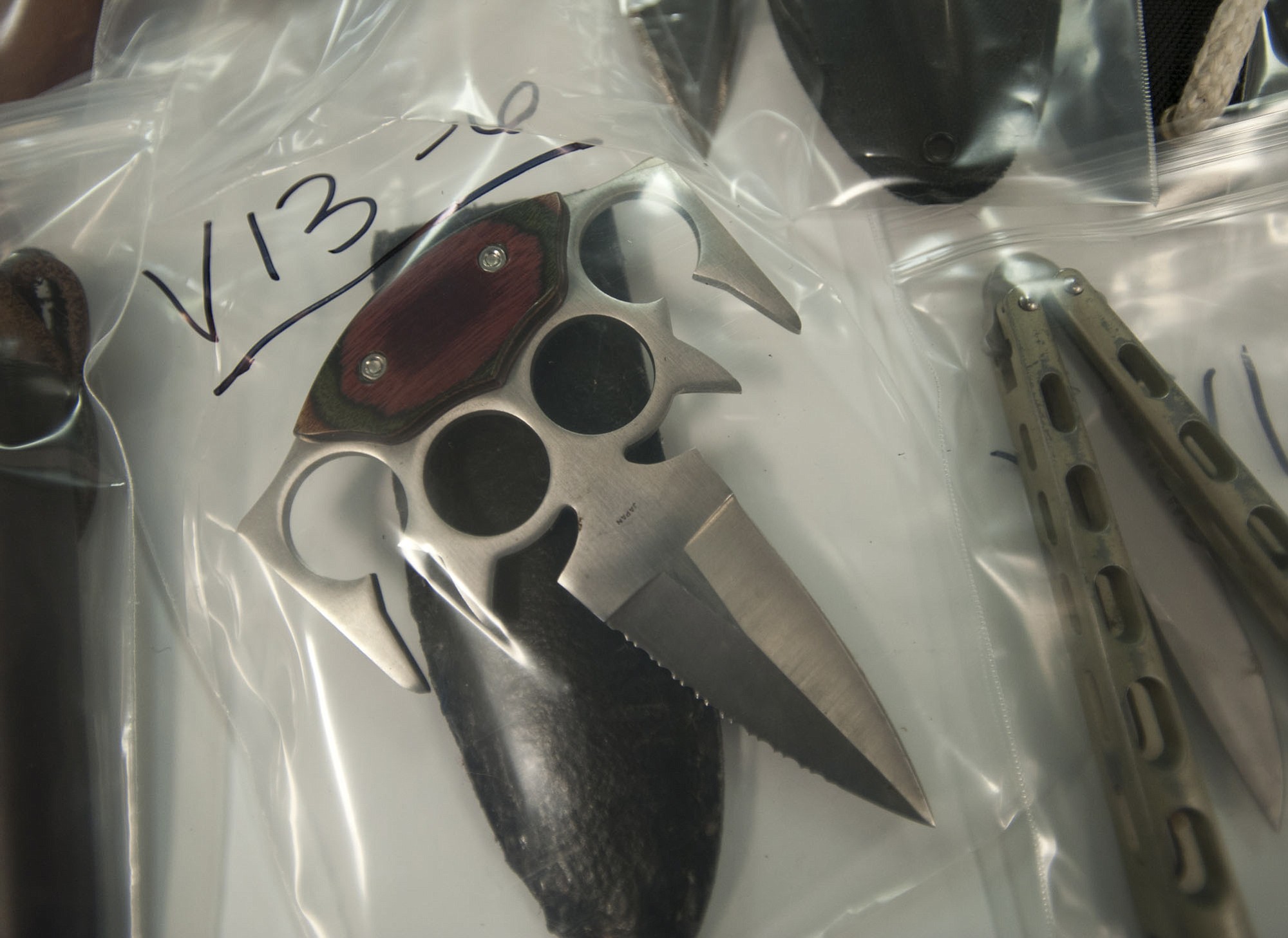 A brass knuckles knife sits among hundreds of packaged property that Vancouver police recovered during an investigation into a string of property crimes.