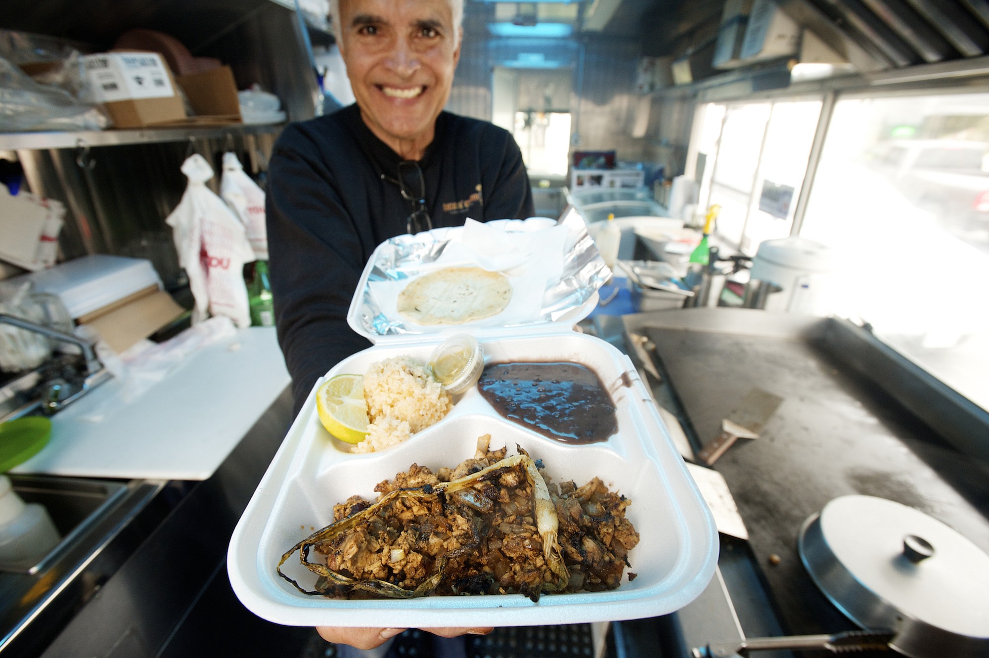 Chester-Castillo Morales, owner of the Tacos n' Cream food truck, shows the El Chico Plato chicken taco meal on Jan.