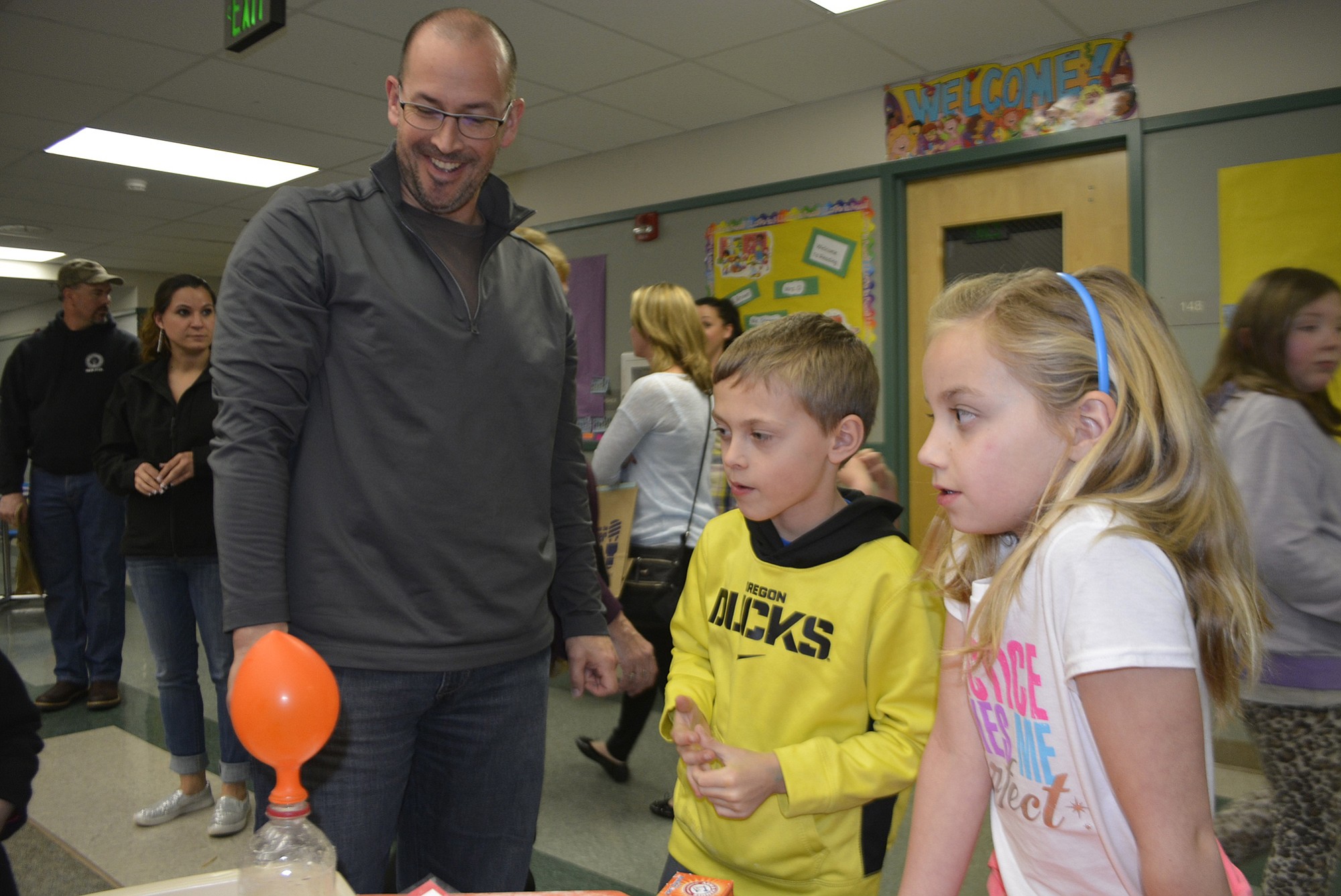 Washougal: John McCormick, left, with his children, Connor and Gabby McCormick, watch a balloon expand from a chemical reaction during Cape Horn-Skye Elementary School's Family Science Night.