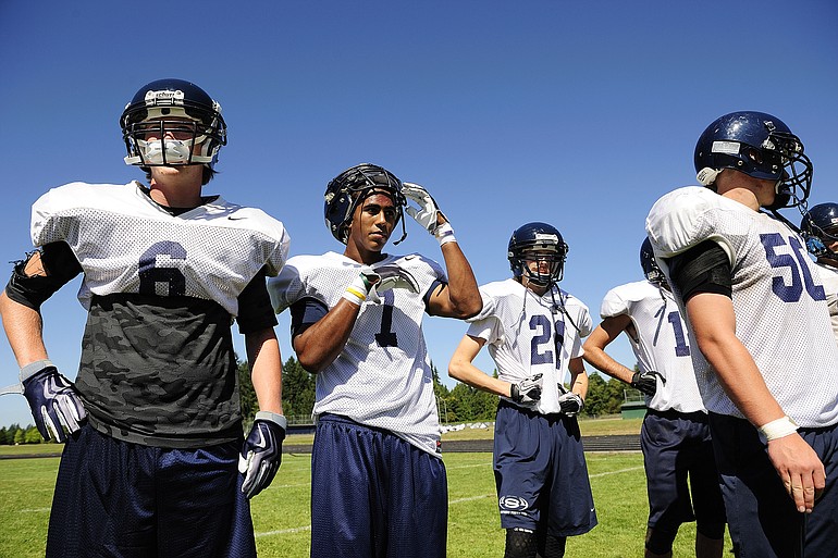 Wide receivers Karl Graves (6) and Ellis Henderson (7) wait with teammates during practice at Skyview High School Monday morning August 23, 2010.