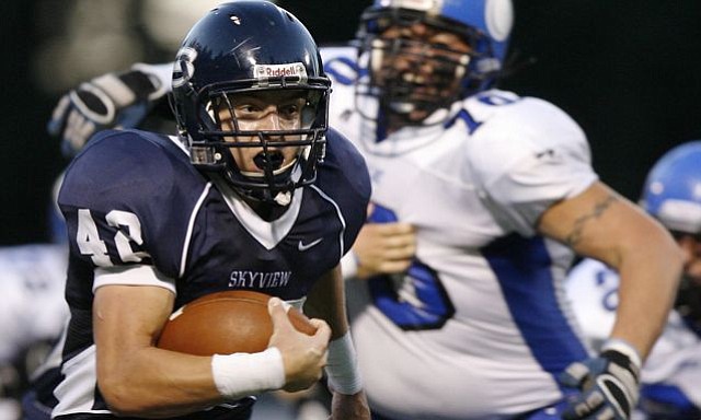 Parker Henry (L) of Skyview runs for a touchdown against Coeur d'Alene during the first quarter of high school football game Saturday night at the Kiggins Bowl.