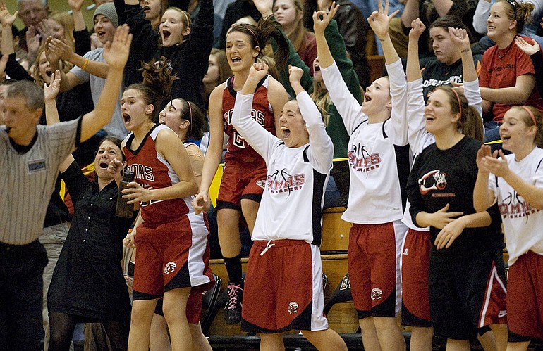 The Camas girls basketball team celebrates a made three point shot during a win over Prairie for the district championship title at Hudson's Bay, Friday, February 19, 2010.