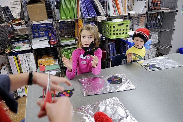 Sophie Martin and Keenan Barton, both age 7, listen to instructions from teacher Krista Moore during a Vancouver Home Connection visual arts class at Vancouver Public Schools' Jim Parsley Community Center.
