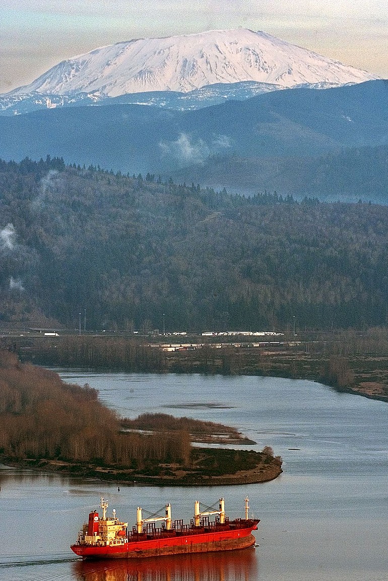 Roger Werth, File/The Daily News
With Mount St. Helens in the distance, a cargo ship moves upriver on the Columbia River near the Cowlitz River in 2005. The Columbia has served industrial needs for going on two centuries.