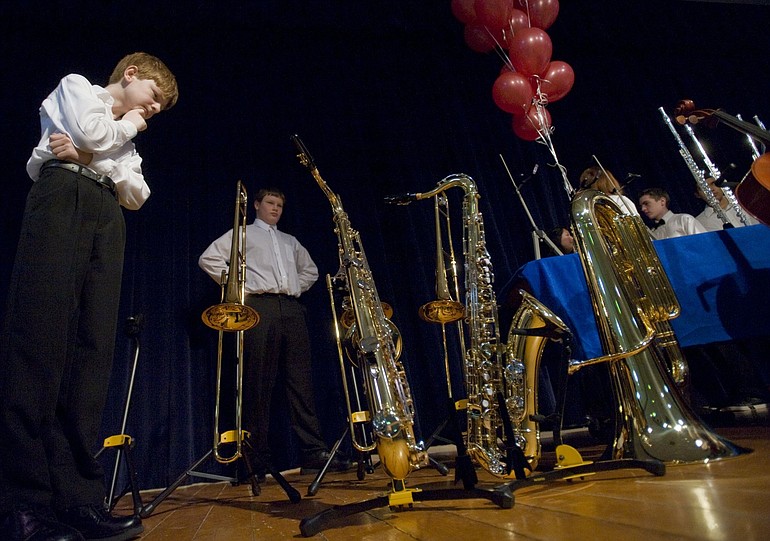 Discovery Middle School musician Ben Giles, 12, inspects a pair of tenor saxophones, among 18 instruments donated to his school by The Amphitheater at Clark County. The amphitheater teamed with the national Mr.