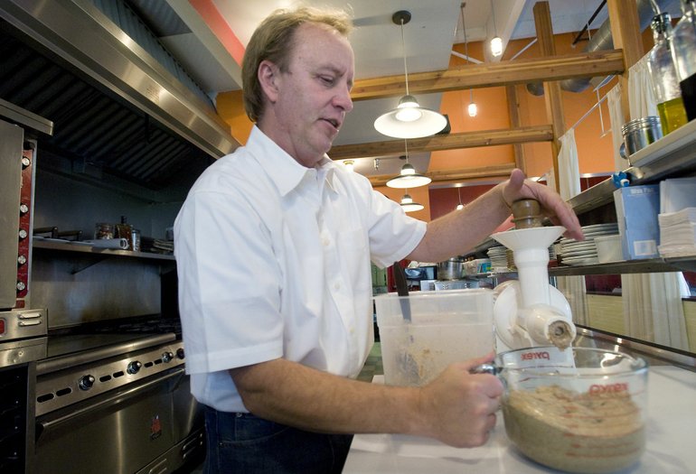 Ken Condliff makes almond butter inside a Vancouver commercial kitchen.