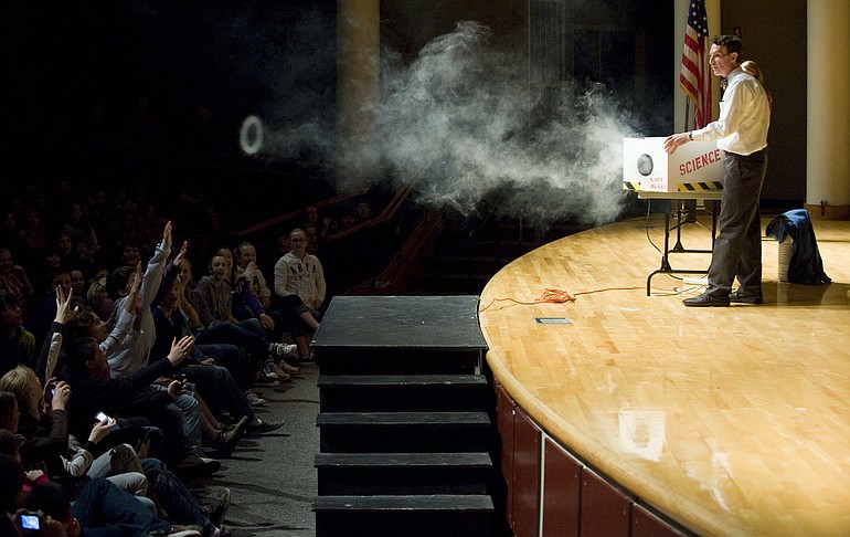 Bill Nye uses theater smoke to demonstrate the concept of fluid mechanics for 1,000 Vancouver sixth-grade students Thursday in the Skyview High School auditorium.