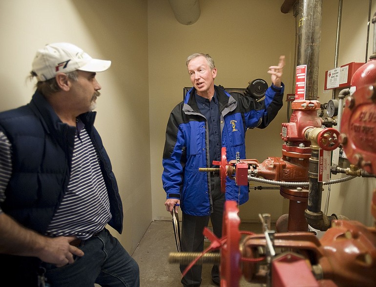 Ken Hill, Clark County Deputy Fire Marshal, right, inspects the sprinkler room at Arbor Ridge Assisted Living Community with maintenance director Karl Hohnholz last week.