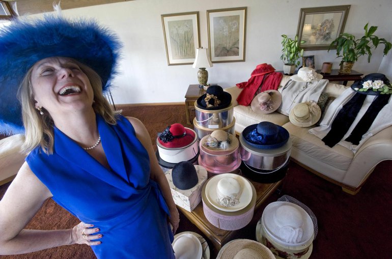 Gail Bauhs of Vancouver models a blue-and-white feathered hat she once wore to an Easter church service. Bauhs said she found the blue dress 18 years after she bought the hat.