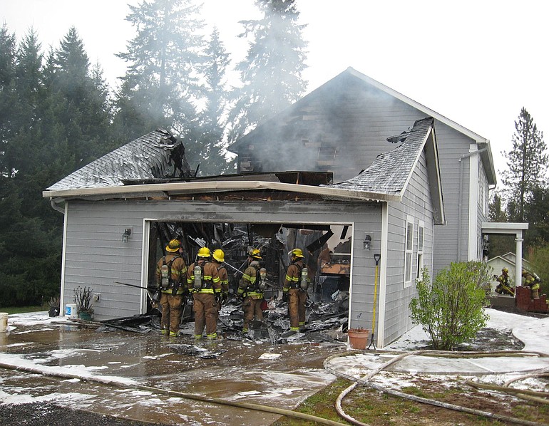 After extinguishing a blaze at a Brush Prairie home, firefighters discuss dealing with some remaining hot spots.