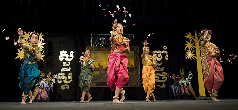 Dancers toss flower petals toward the crowd during last year's Cambodian New Year Celebration at Clark College.