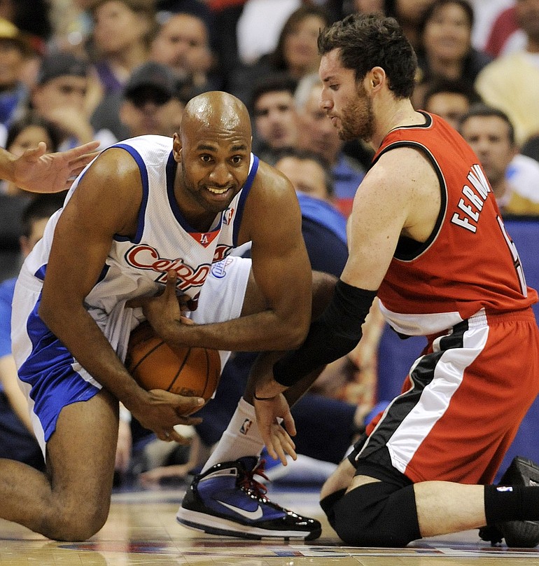 Los Angeles Clippers' Mardy Collins, left, tries to keep the ball away from Portland Trail Blazers' Rudy Fernandez, of Spain, during the first half of an NBA basketball game in Los Angeles, Wednesday, April 7, 2010.