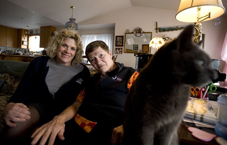 Julie Williams, left, owner of Home Instead Senior Care, visits client Lorraine Bohren at her home.