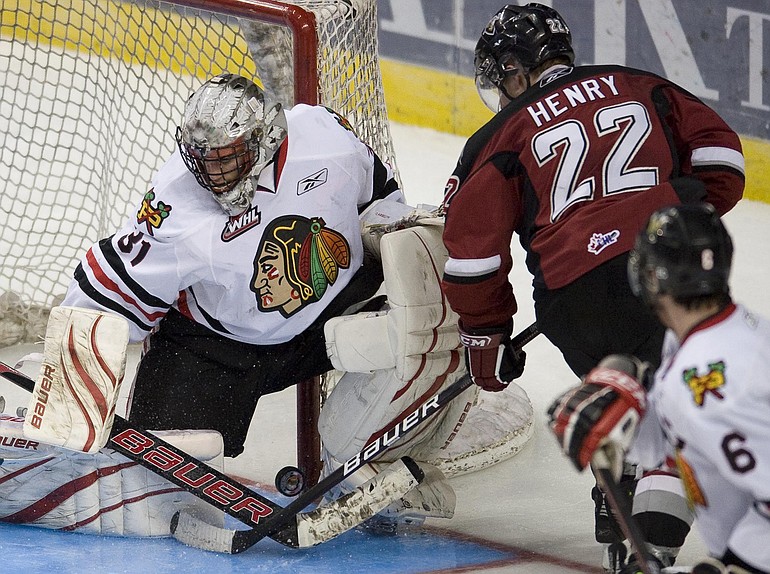 Vancouver's James Henry (22) gets the puck past Winterhawks goaltender Mac Carruth to give the Giants a 3-1 lead Tuesday.