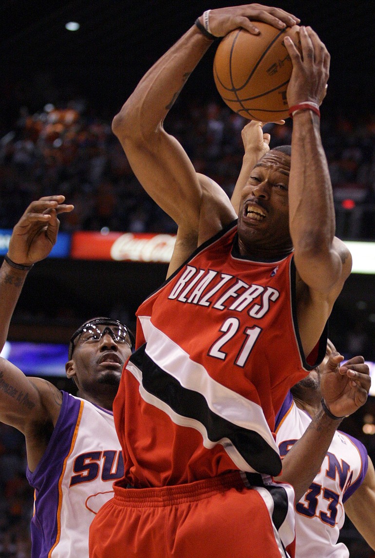 Trail Blazers center Marcus Camby hauls in a rebound in front of Phoenix forwards Amare Stoudemire, left, and Grant Hill during Game 1.