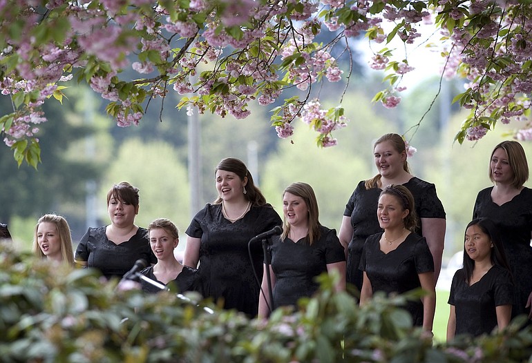 The Clark College Women's Choral Ensemble serenades a crowd at the Sakura Festival in the cherry tree grove on campus.