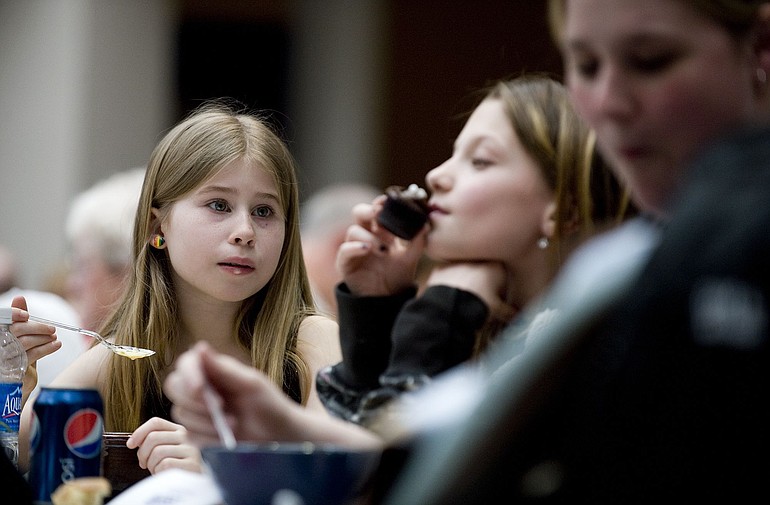 Ashley Dolley, 8, left, from West Linn, Ore., eats her potato soup as her friend Samantha Hoppa, 9, from Vancouver, moves on to dessert at the ninth annual Share-a-Bowl Fundraising Dinner.