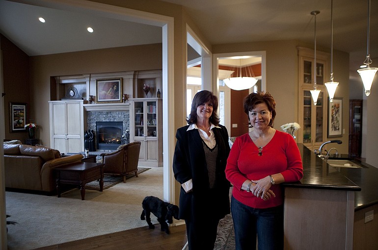 Nancy Kelly, left, a real estate agent with the Hasson Co. Realtors in Vancouver, credits &quot;more realistic&quot; home sellers such as Marie Bartley, right, for improving sales of high-end homes in the Clark County market. The home was listed for about $700,000.