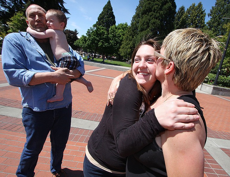 Andrea Reynolds of Molalla, Ore., gets a kiss from her mom, Jeanette Armstrong of Vancouver, as they spend time on Mother's Day in Esther Short Park.