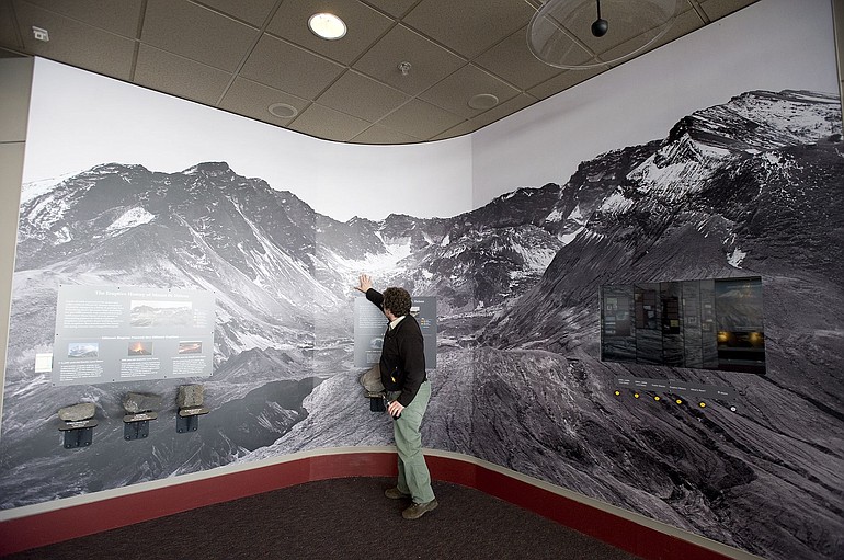 Monument scientist Peter Frenzen discusses a panoramic mural depicting the Mount St. Helens crater.