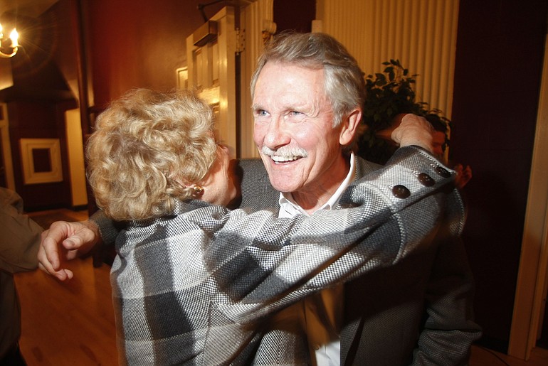 Democratic gubernatorial candidate John Kitzhaber receives a hug from ex-politician Norma Paulus before making remarks during an election night celebration Tuesday in Portland.