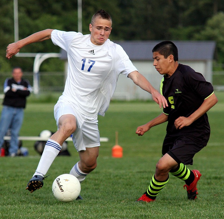 Ridgefield's Travis Heim, left, plays against Lynden's Daniel Huante in a 2A state soccer playoff match at Ridgefield on Tuesday.