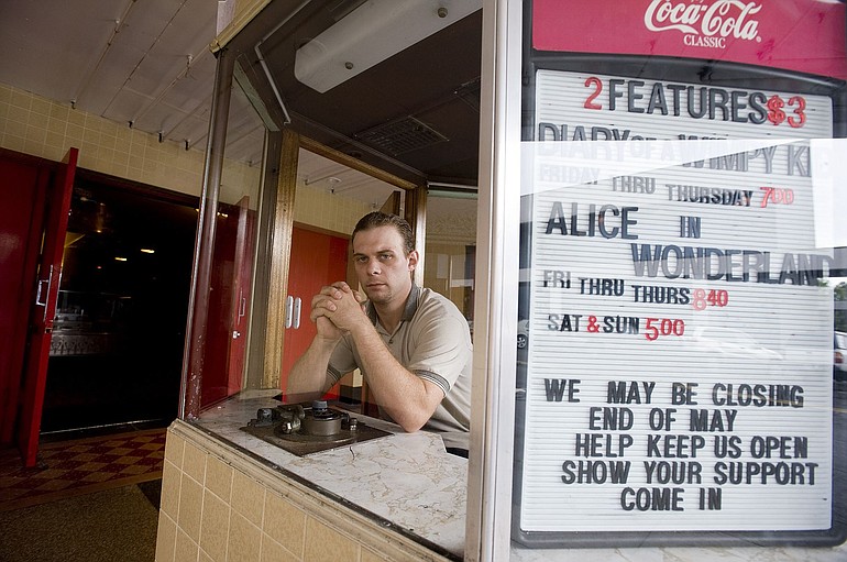 Matthew West, a manager of the Kiggins Theater, prepares the old movie house for its Friday night shows.
