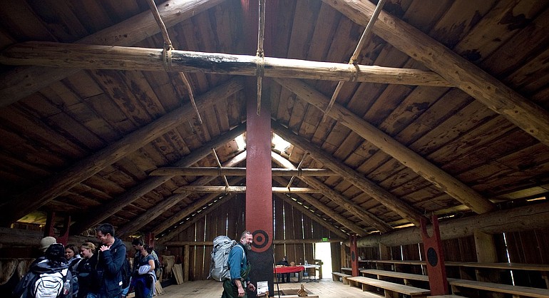 Dr. Michael Jones, center, examines the interior of the Cathlapotle Plankhouse at the Ridgefield National Wildlife Refuge with students in his Ecology class at Mt. Hood Community College.