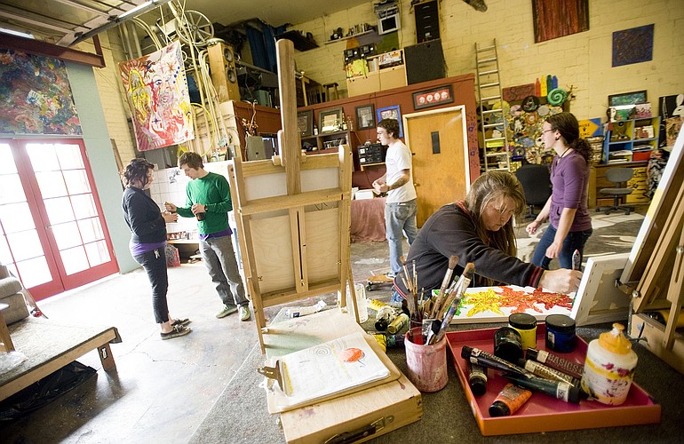 Colleen Lindsay, foreground, paints at The Space Artists Collective.