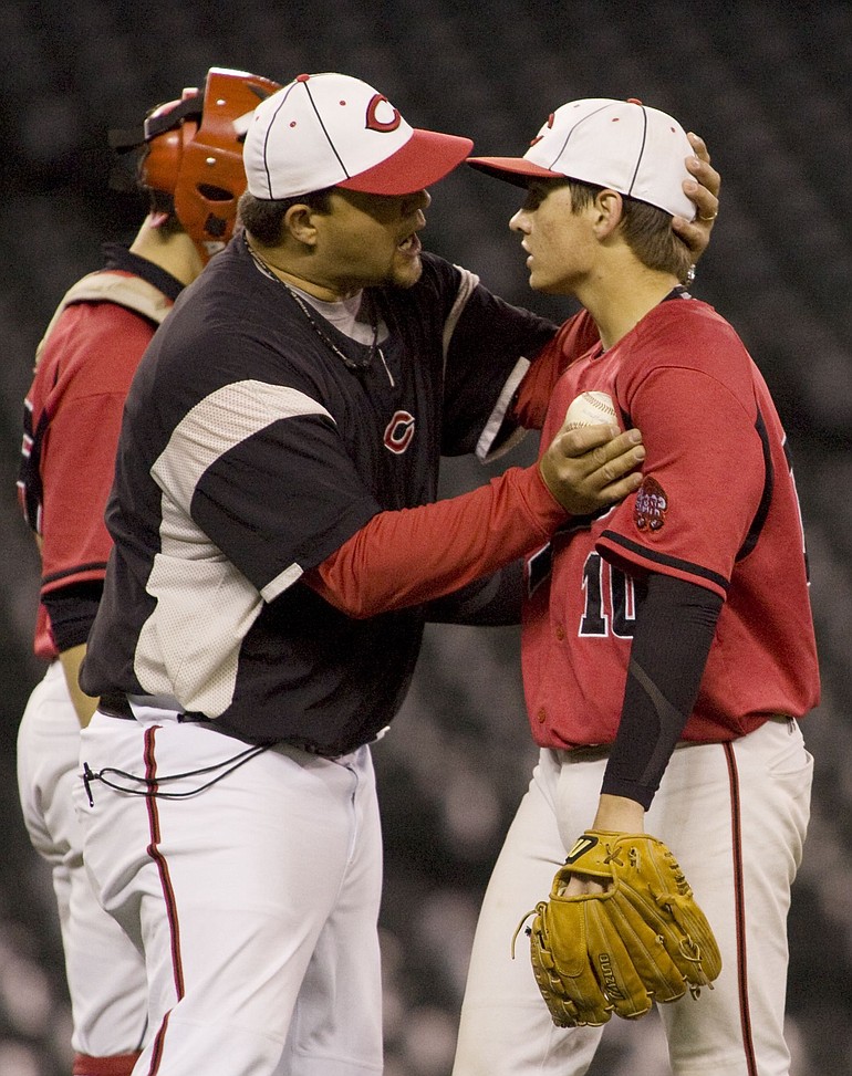 Camas Papermakers' coach Joe Hallead talks to his pitcher Ryan Patterson after removing from the game against O'Dea  in the sixth inning of a 3A Championship baseball game.