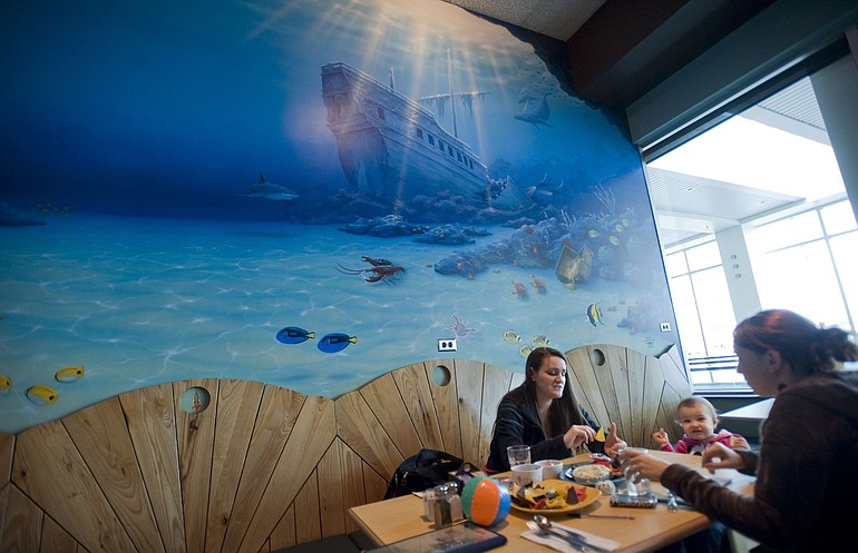 Krista Lindow, 23, left, her daughter, Isabelle Bernier, 1, and Kelsey Stuart, 20, all of McMinnville, Ore., enjoy a snack at the new Beaches Restaurant &amp; Bar inside the Portland International Airport while waiting for a friend's flight to arrive.