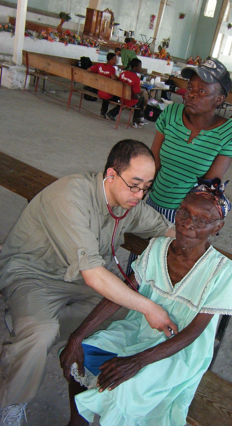 Rico Selga examining a patient at a clinic in Haiti