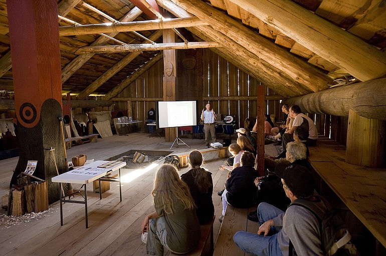 Author and scientist Dennis Dauble talks about fish to a group inside the Cathlapotle plank house at the Ridgefield National Wildlife Refuge on Sunday.