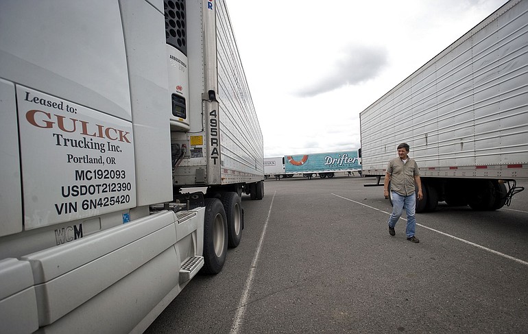 Truck owner Anatoli Astapovich, of Beaverton Ore., inspects his rig at Gulick Freight Service Logistics' Vancouver terminal.