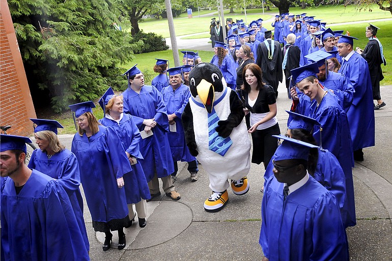 Graduates of the Clark College GED/High School Completion program were visited by Oswald, the school's mascot, as they lined up outside the O'Connell Sports Center before the commencement ceremony Saturday.