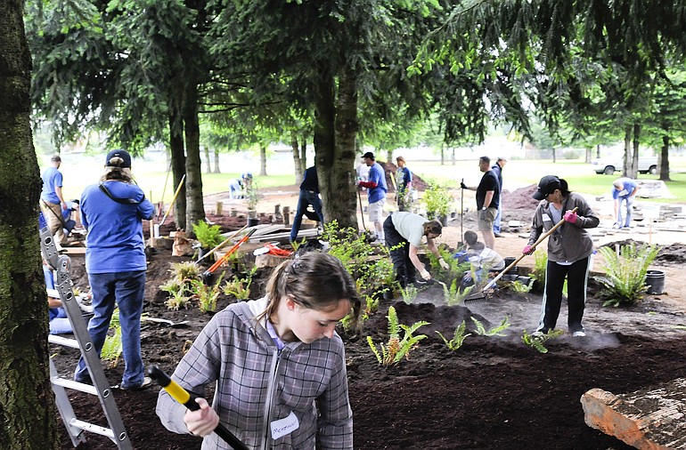 Vancouver Clark Parks and Recreation employees, AmeriCorps volunteers and community members donate time Saturday morning to creating a nature play area at LeRoy Haagen Memorial Community Park in Vancouver